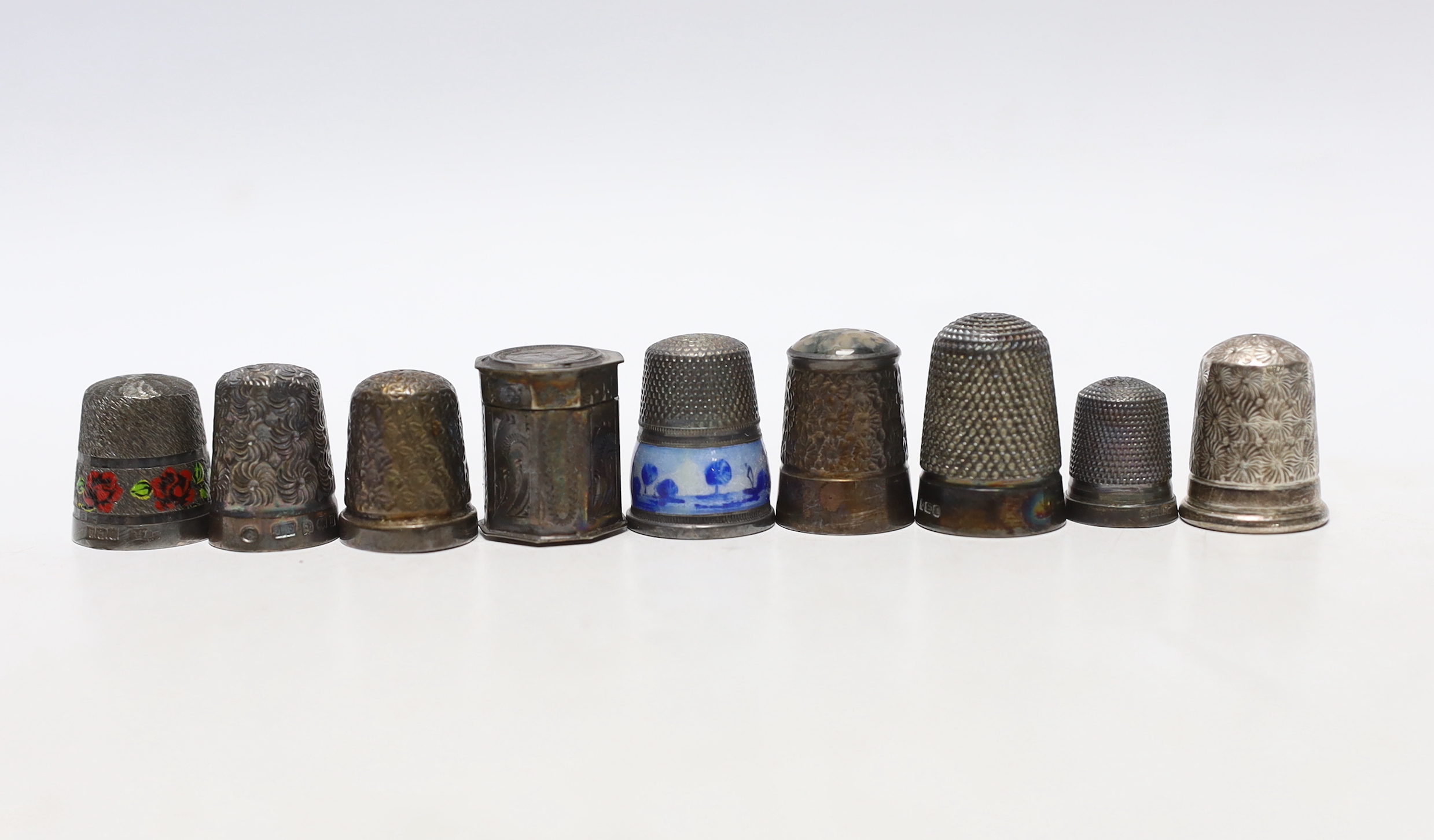 Seven assorted early 20th century and later silver thimbles, including two enamelled and a Dutch? white metal octagonal thimble case.